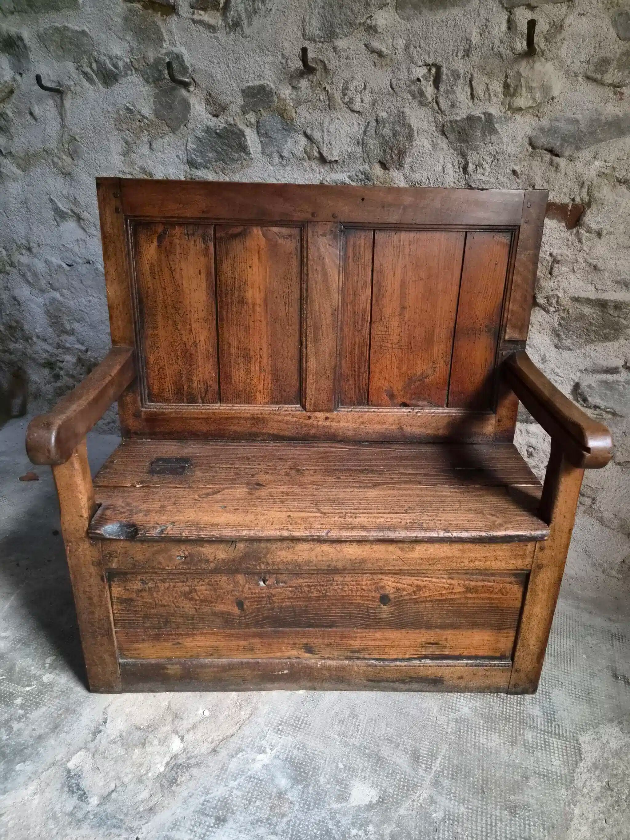 Rustic French antique storage bench from the 18th century in walnut and pine.