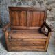 Rustic French antique storage bench from the 18th century in walnut and pine.