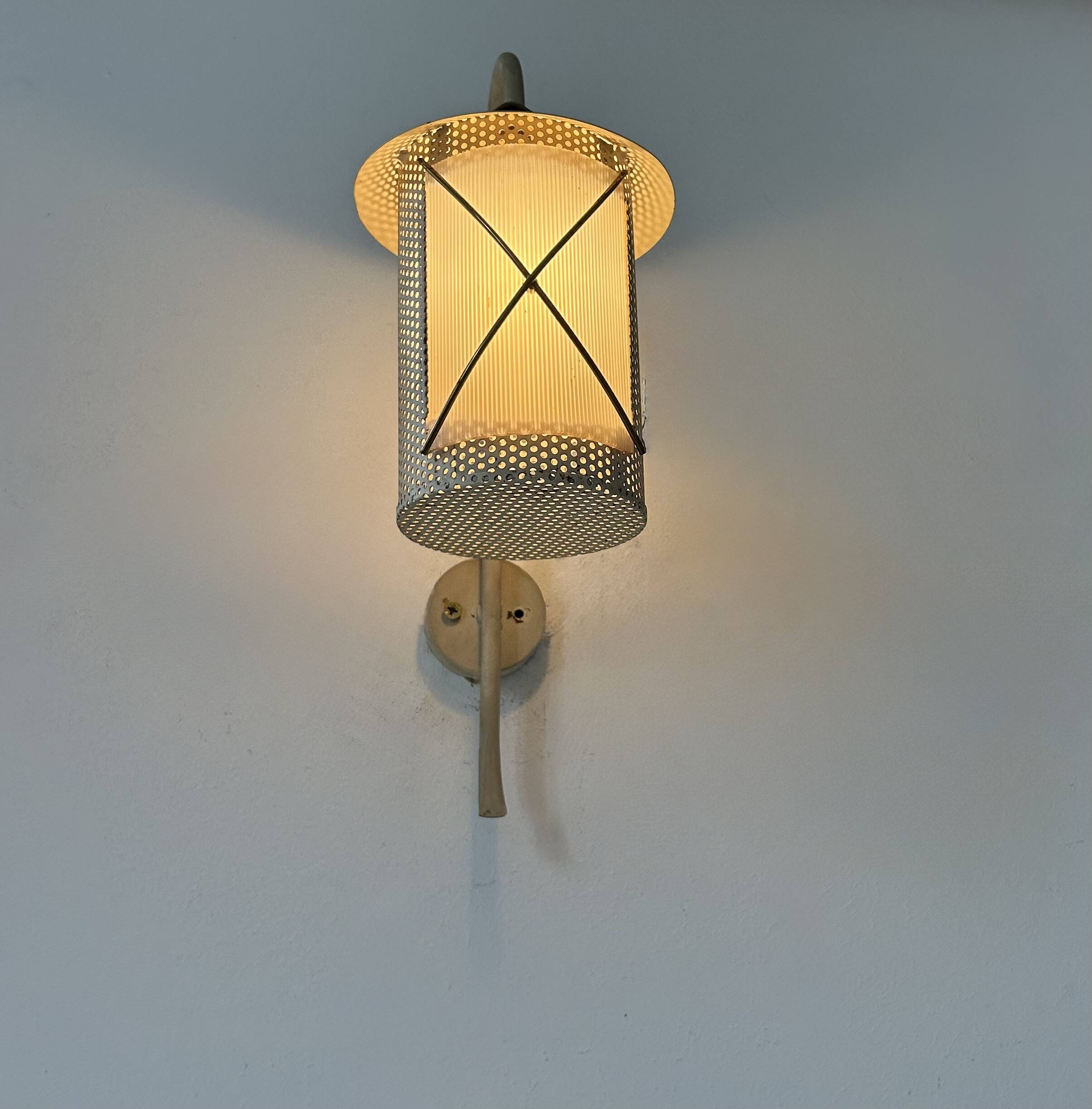 Pair of vintage wall lights in perforated metal, brass, and perspex, France, 1950.