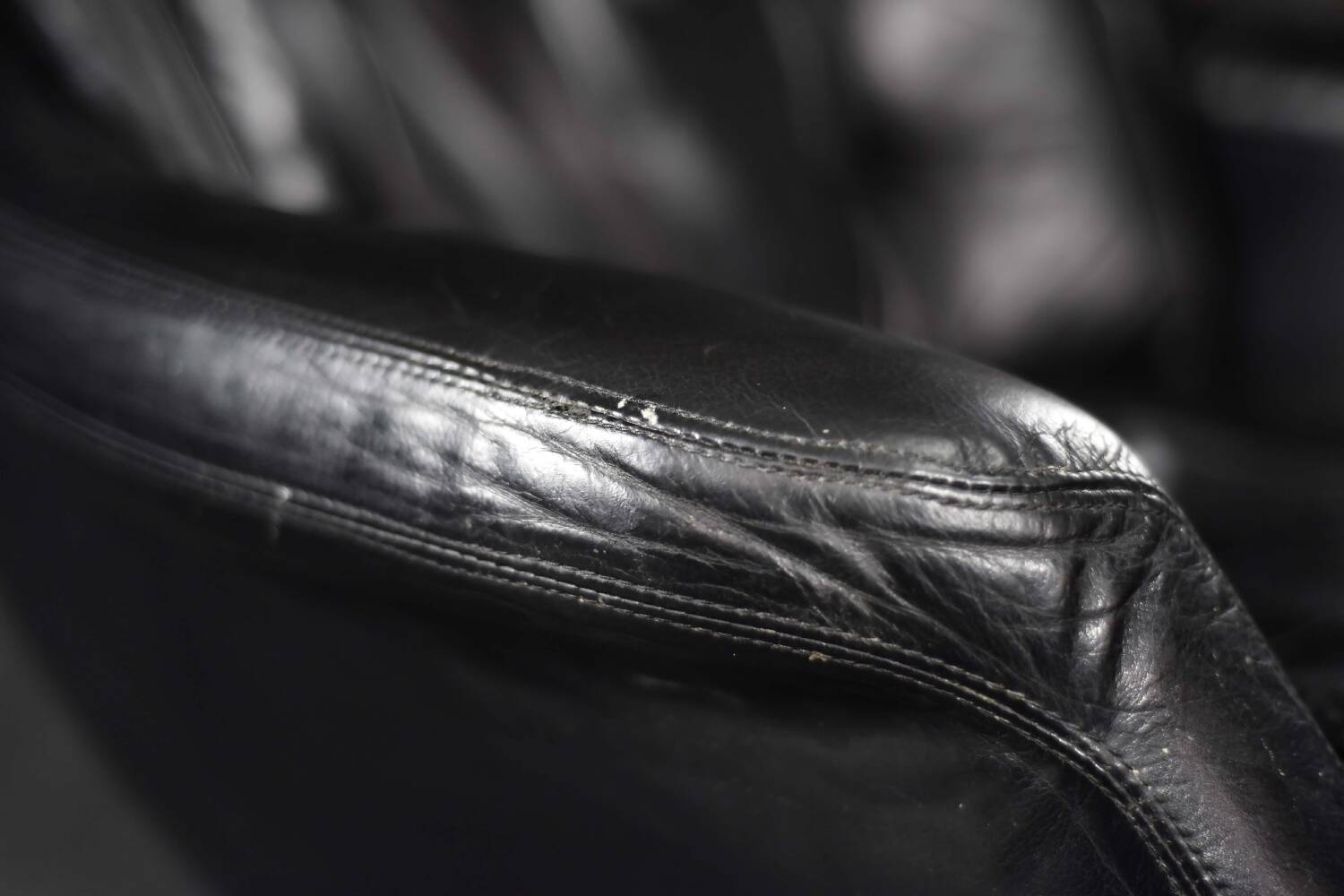 Vintage black leather swivel chair in mid-century modern Scandinavian style.