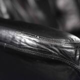 Vintage black leather swivel chair in mid-century modern Scandinavian style.