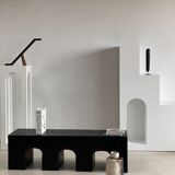 Black solid monoxyl wood bench carved into 3 arches