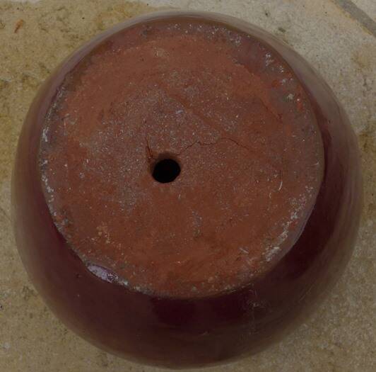 Garnet-colored terracotta flowerpot