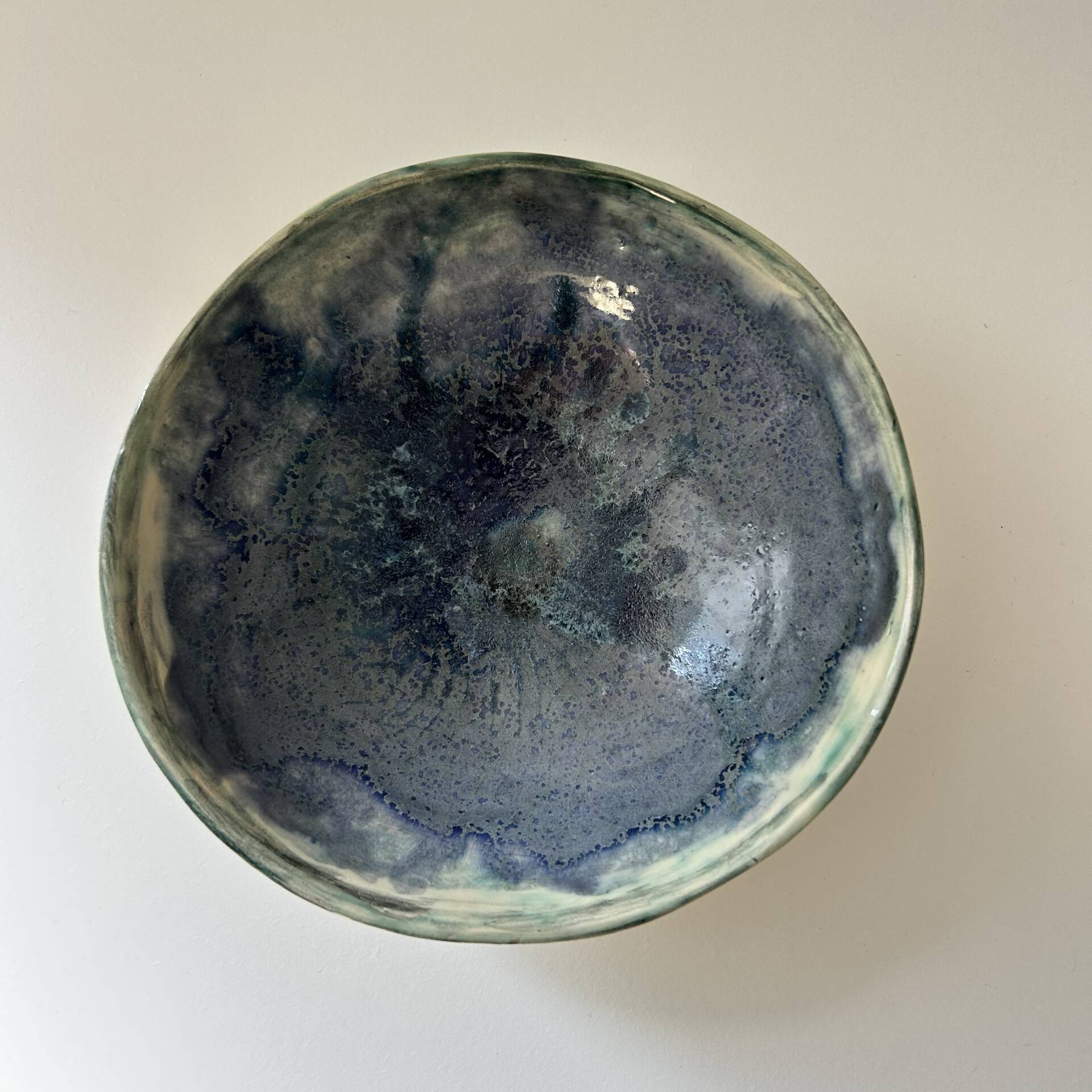 Green bowl signed with an eye