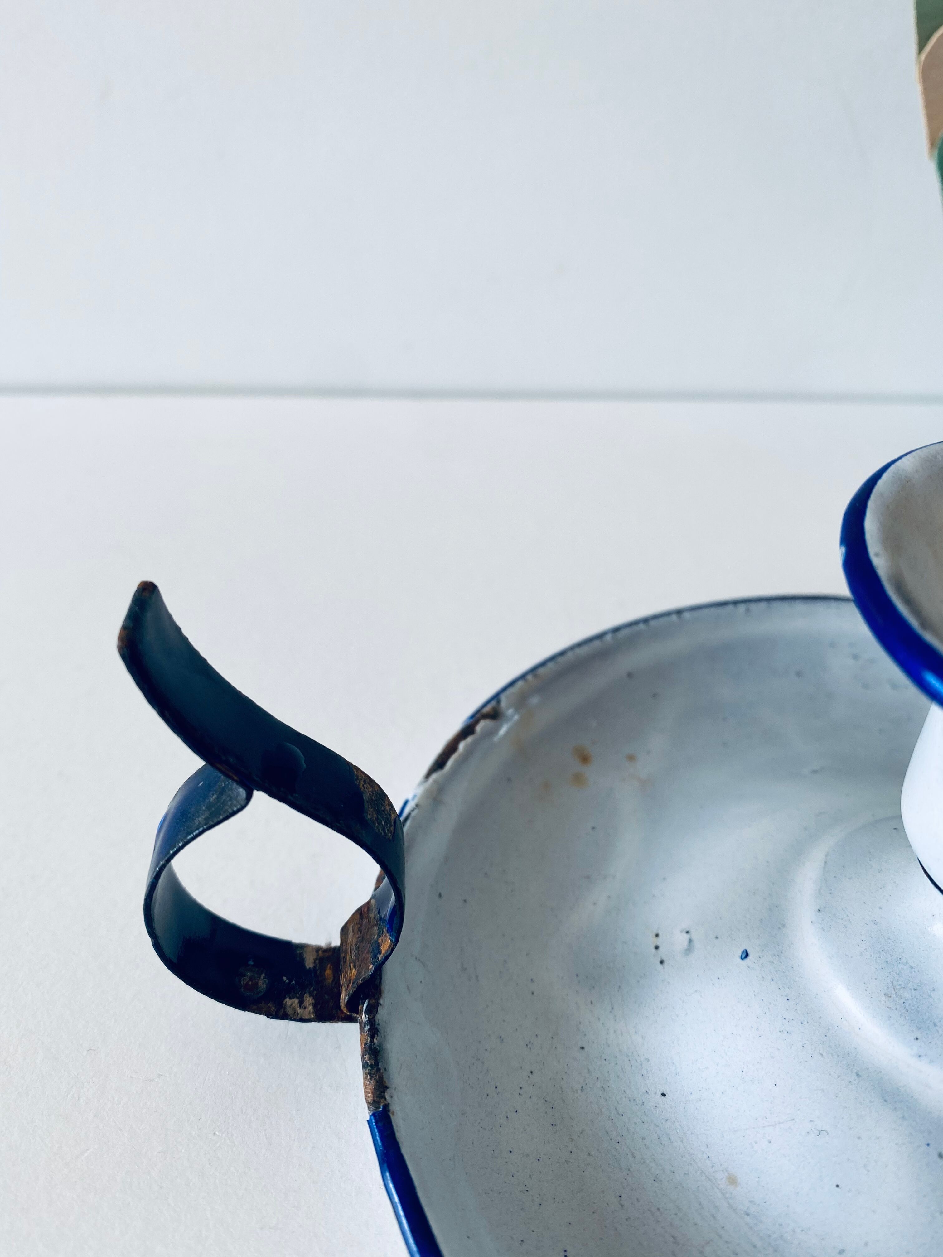 Antique candle holder in white and blue enamelled metal