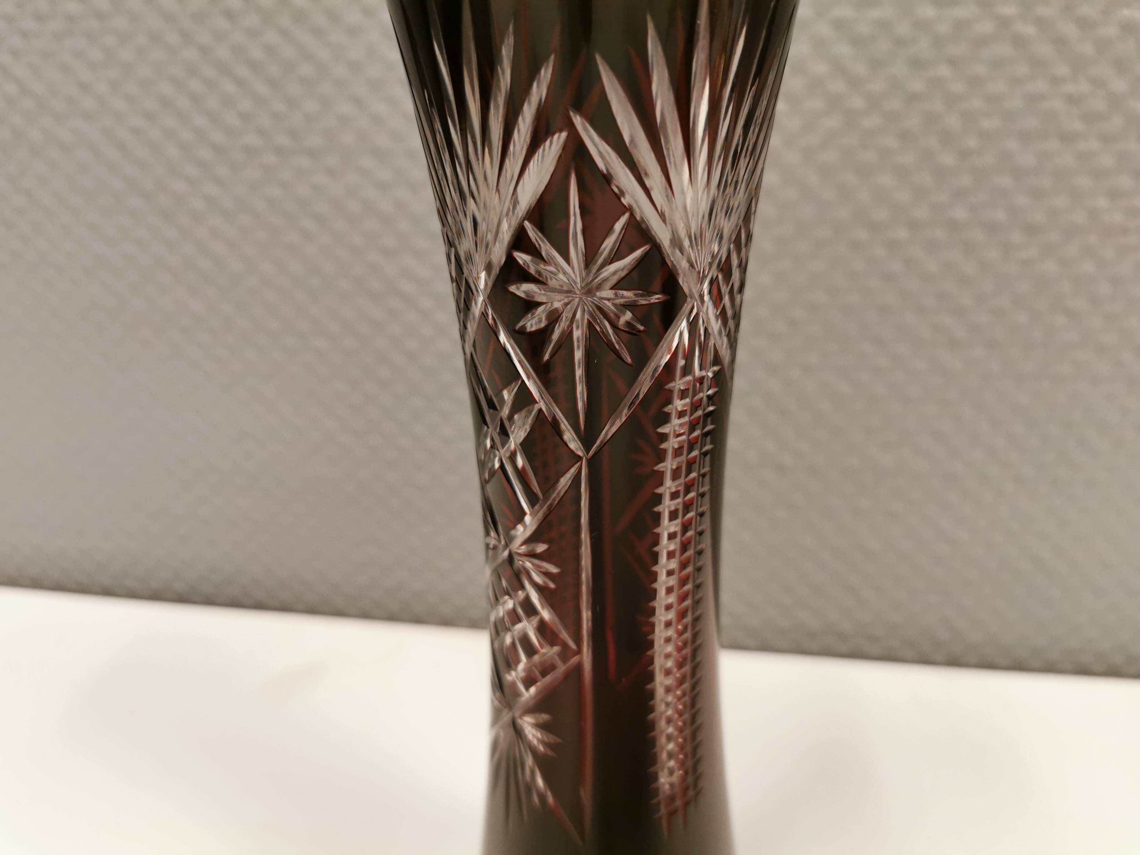 Crystal glass vase, in burgundy/reddish coloured glass with translucent details.