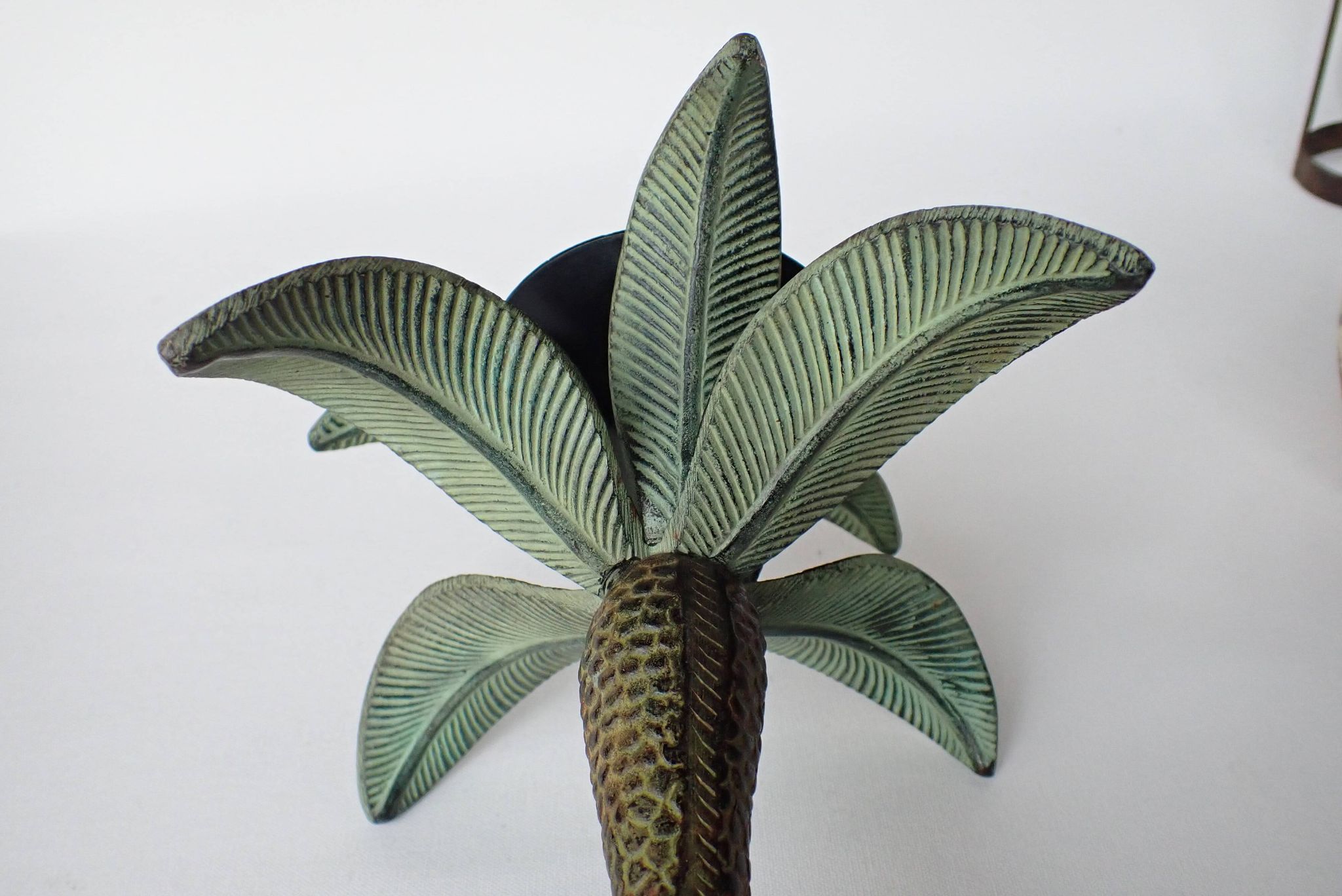 Antique palm tree-shaped candlestick in patinated metal