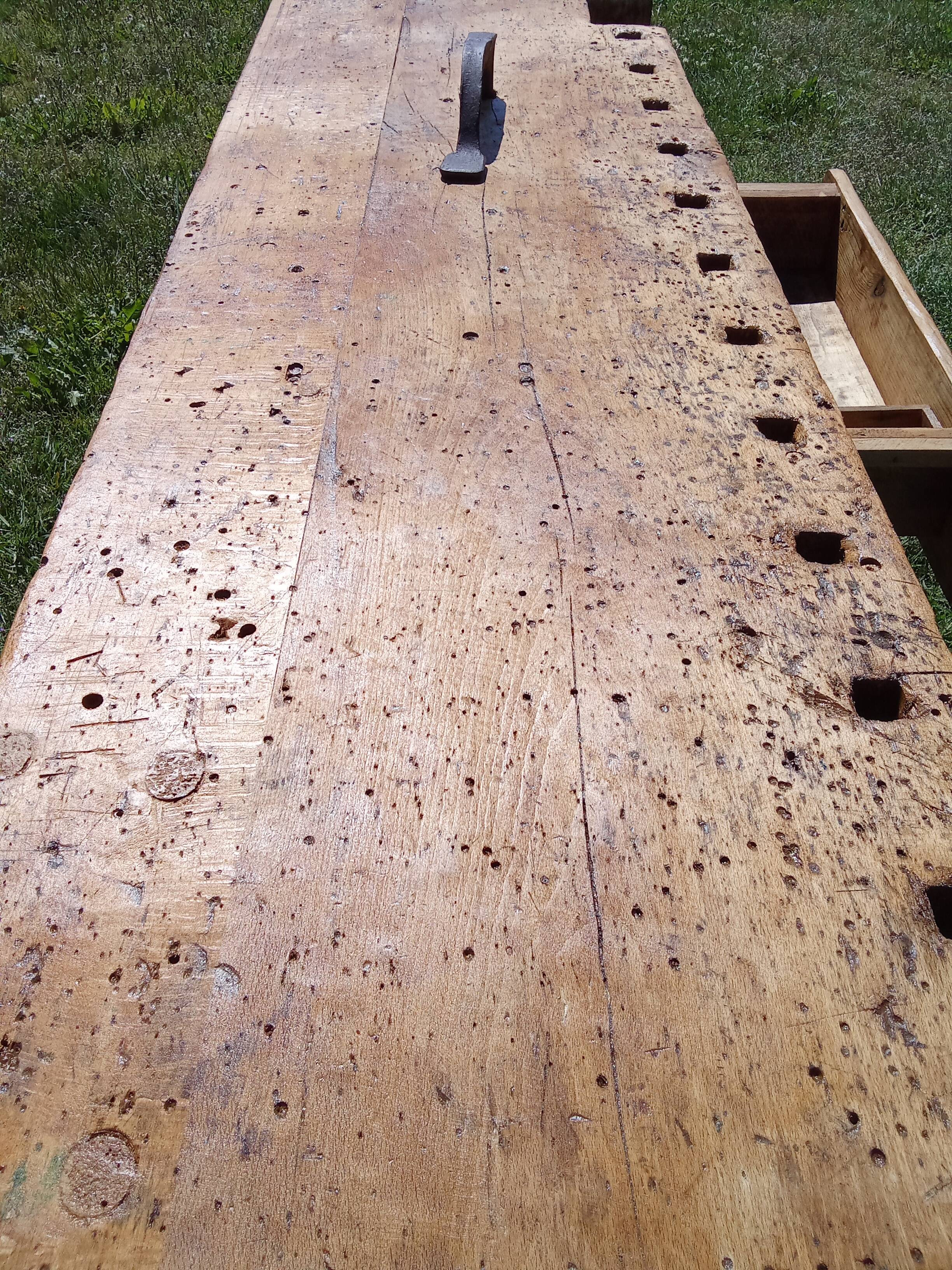 Old solid wood carpenter's bench with 2 functional vices.