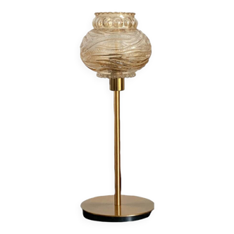 Table lamp with a textured antique globe and a golden base