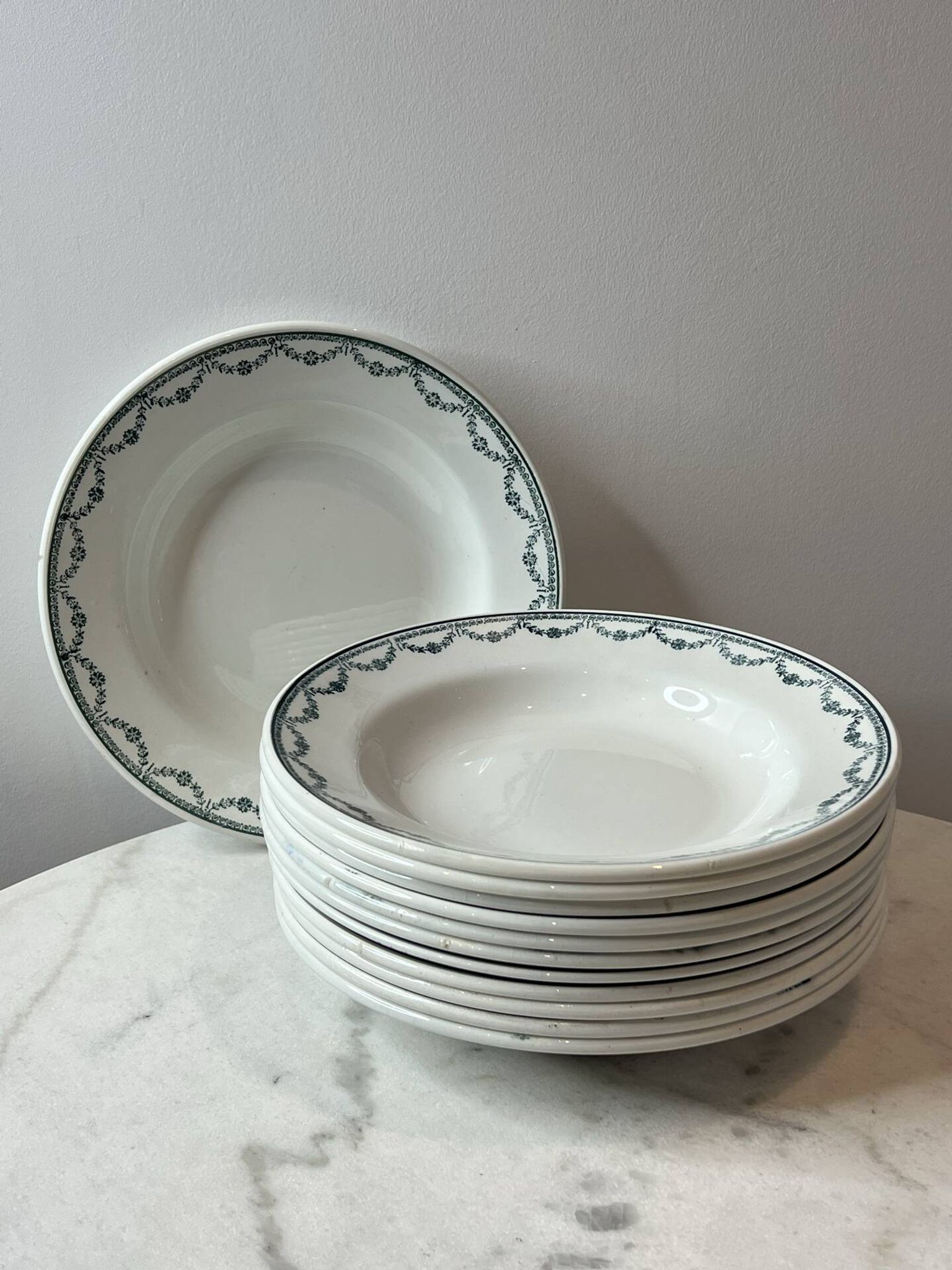 Set of 12 deep plates Saint Amand with floral garland decoration.