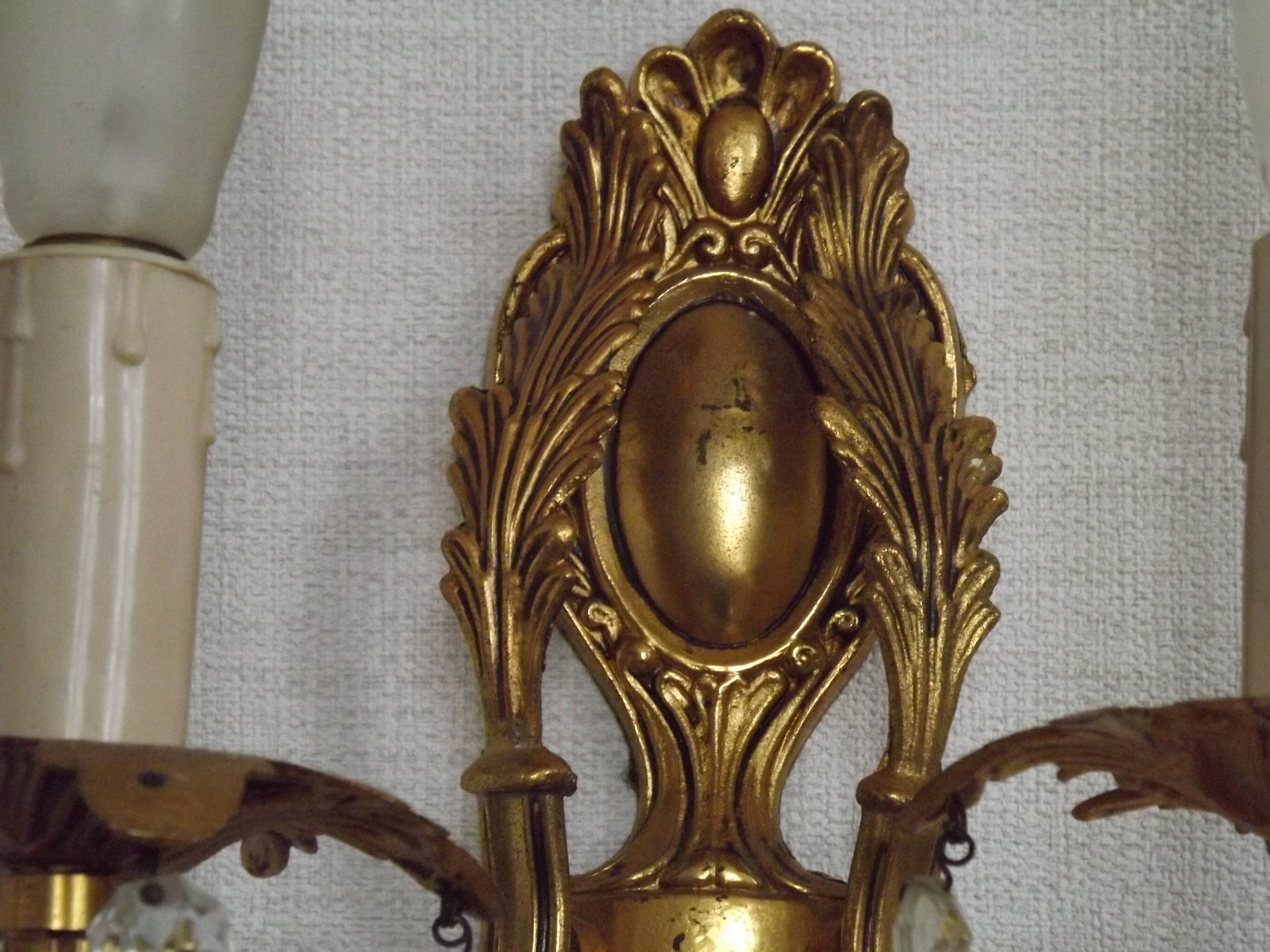 Pair of antique 2-light wall sconces in bronze with crystal pendants, Spain.