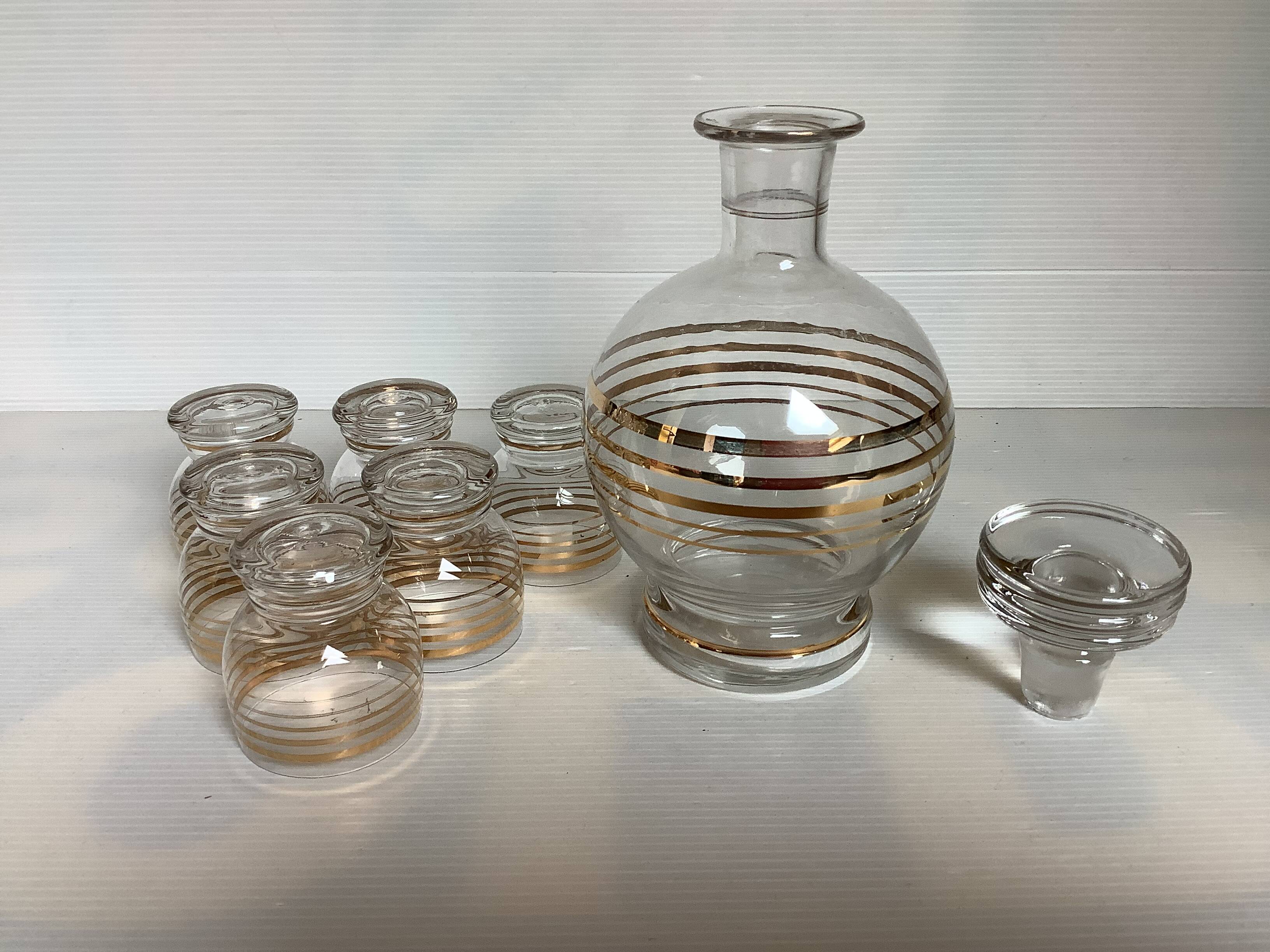Antique liqueur set with a gold rim.