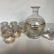 Antique liqueur set with a gold rim.