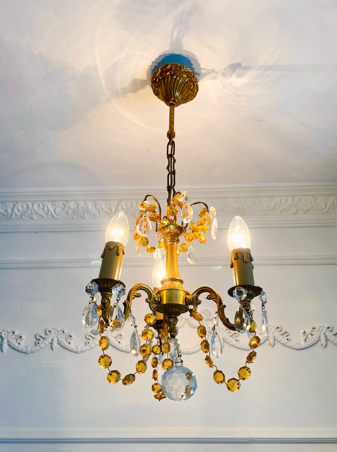 Small vintage brass chandelier with amber crystal pendants.