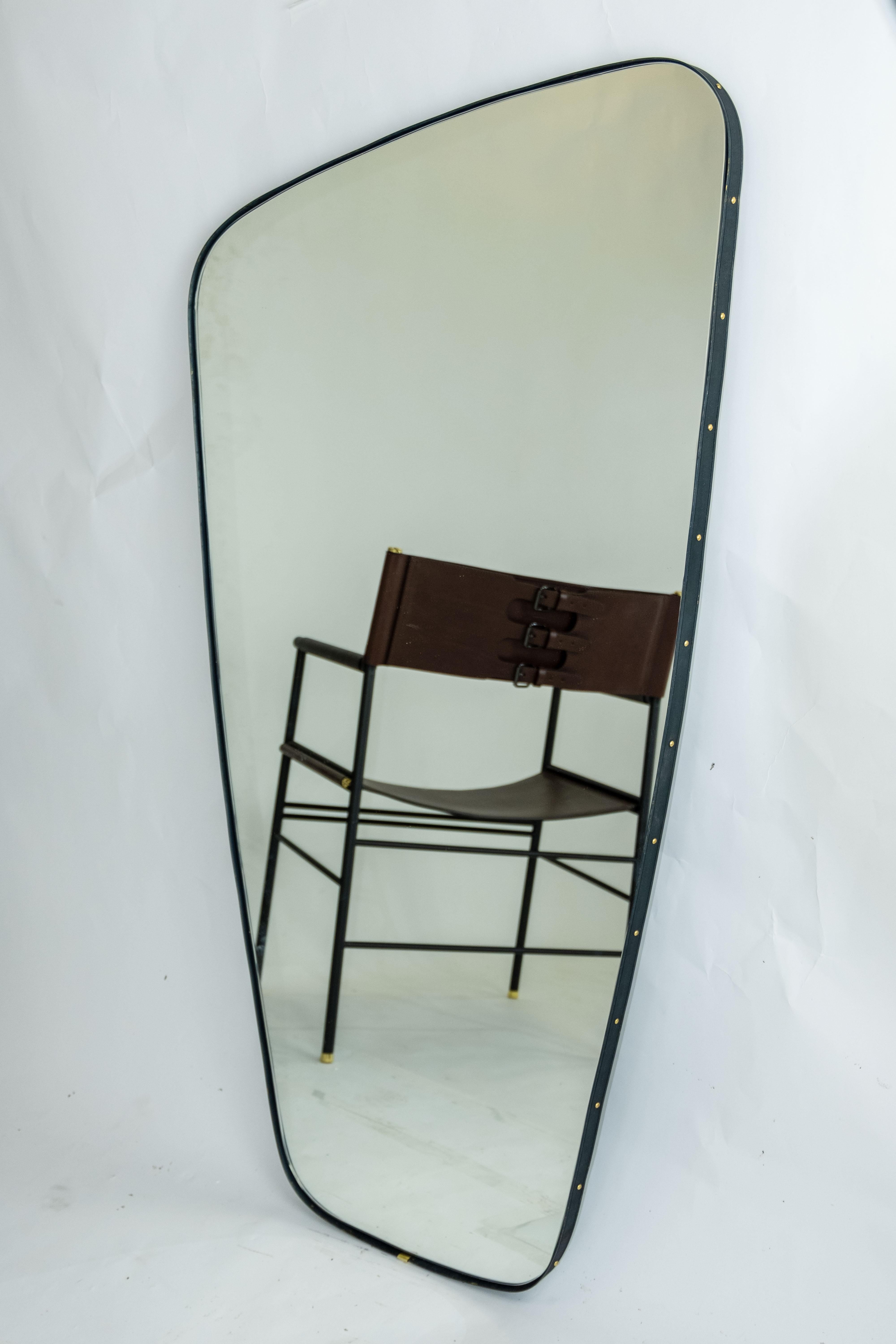 Contemporary rectangular mirror with rounded edges and embossed brass frame.