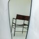 Contemporary rectangular mirror with rounded edges and embossed brass frame.