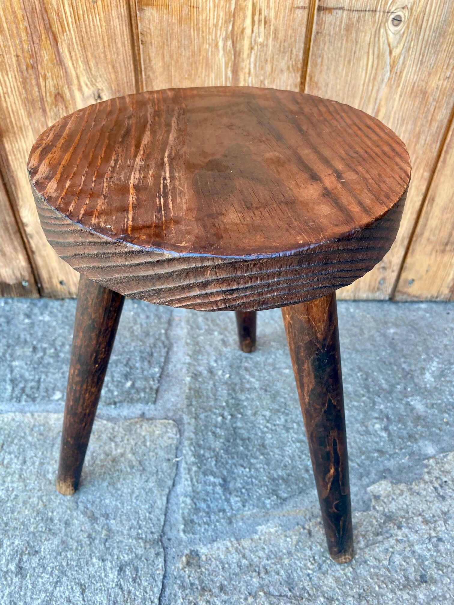 Wooden tripod stool.