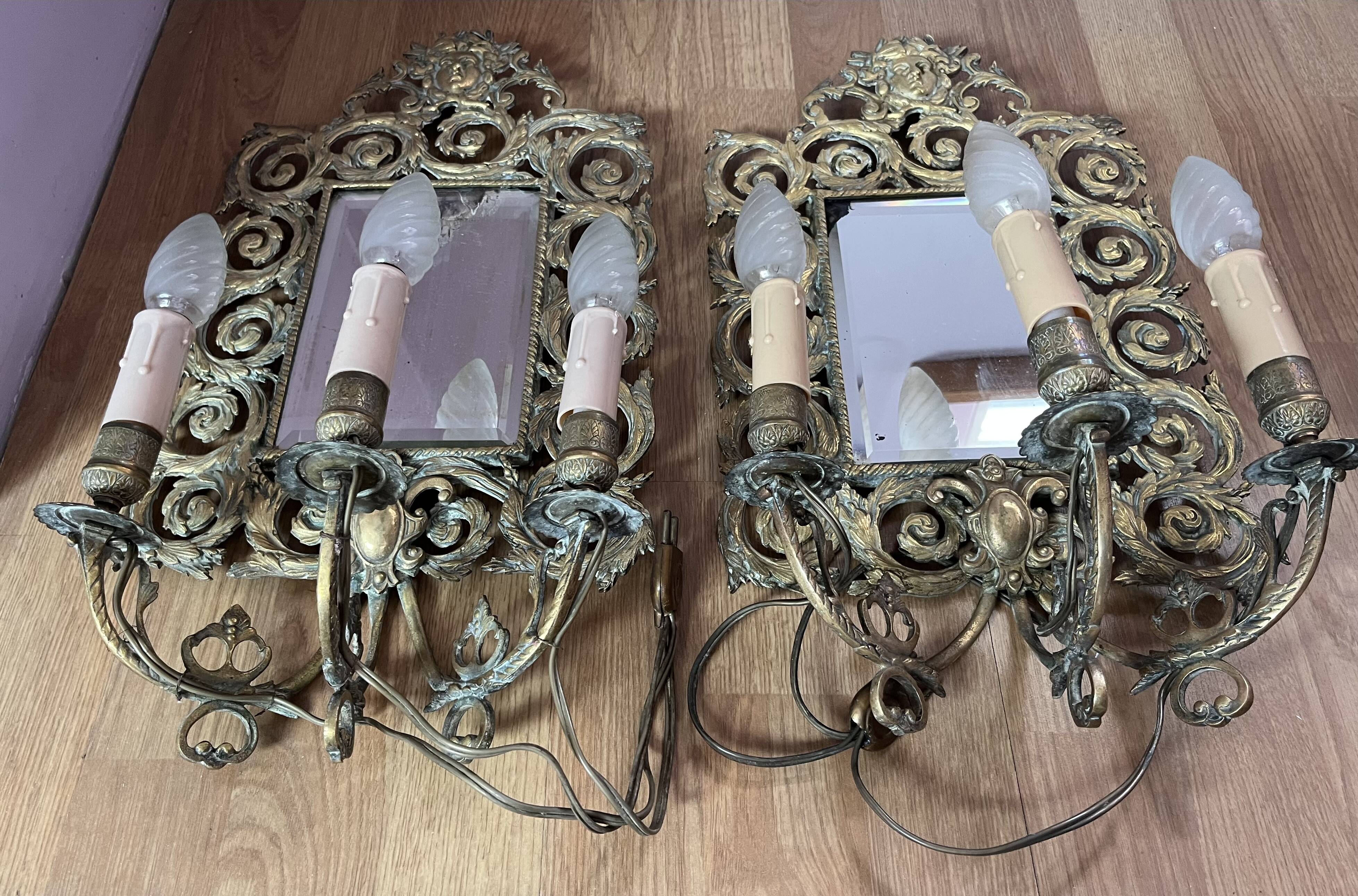 Pair of Napoleon III wall sconces, bevelled mirrors, mask heads.