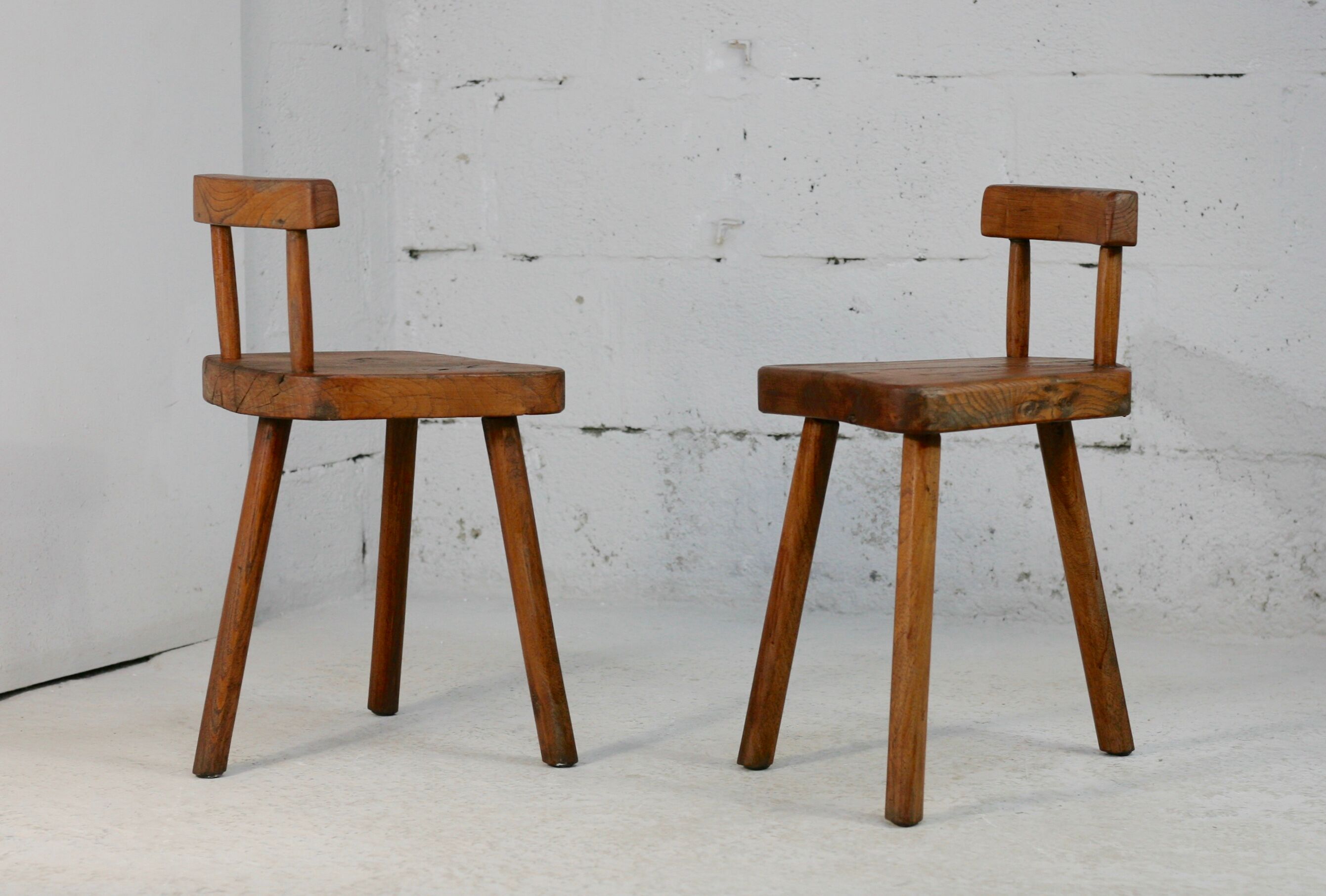 Pair of tripod stools with brutalist backrests, France, circa 1960