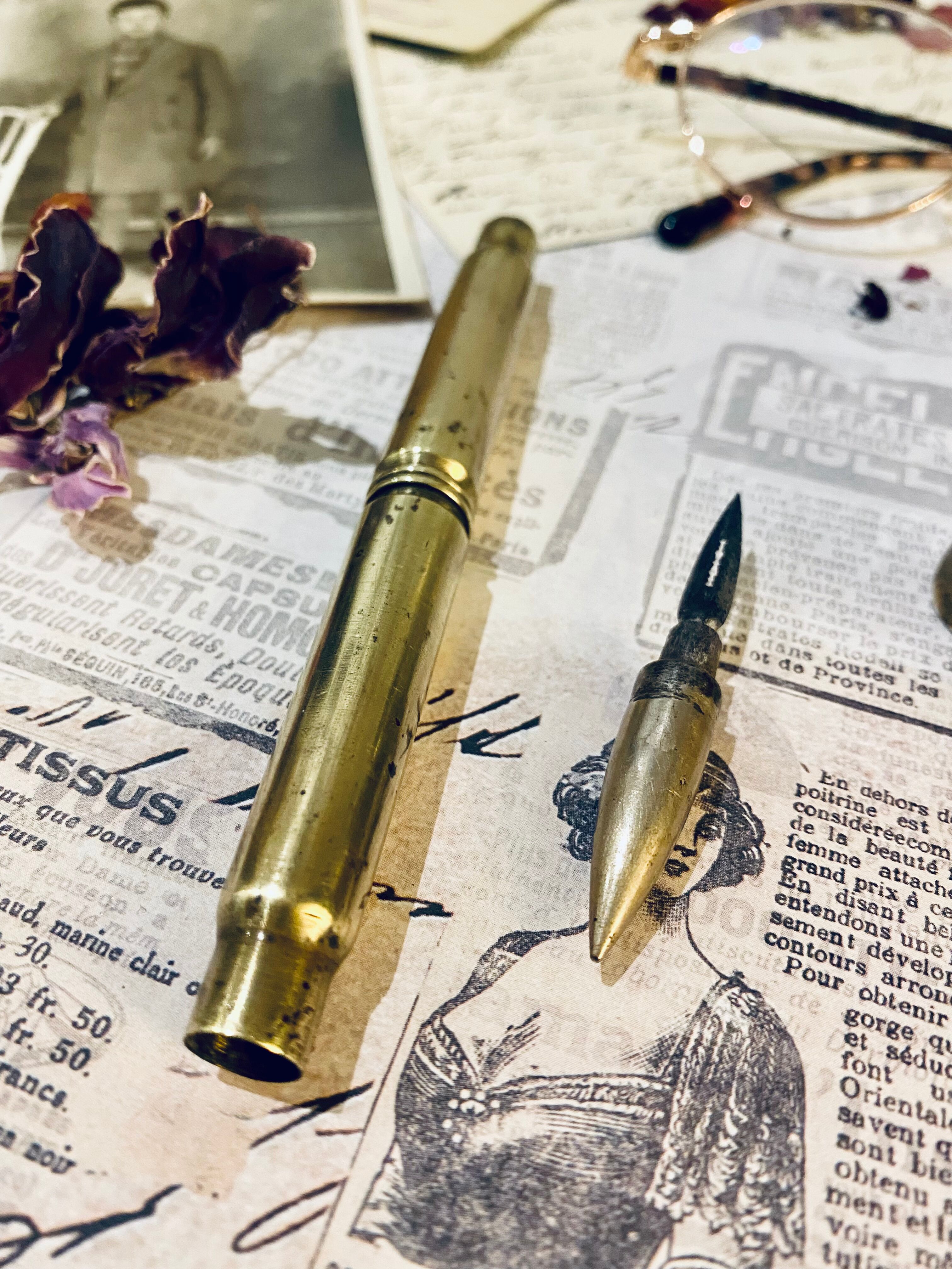 Brass inkwell and old feather holder