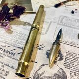 Brass inkwell and old feather holder