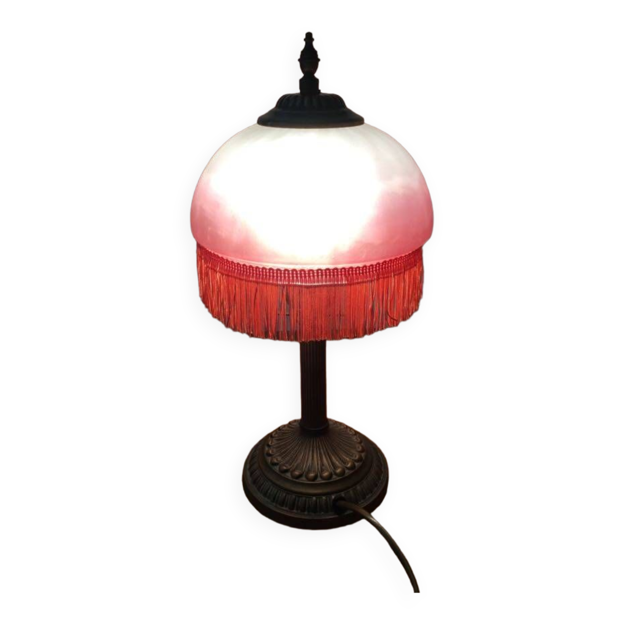 Old table/bedside lamp with glass shade with pink gradients and fringes.
