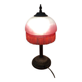 Old table/bedside lamp with glass shade with pink gradients and fringes.