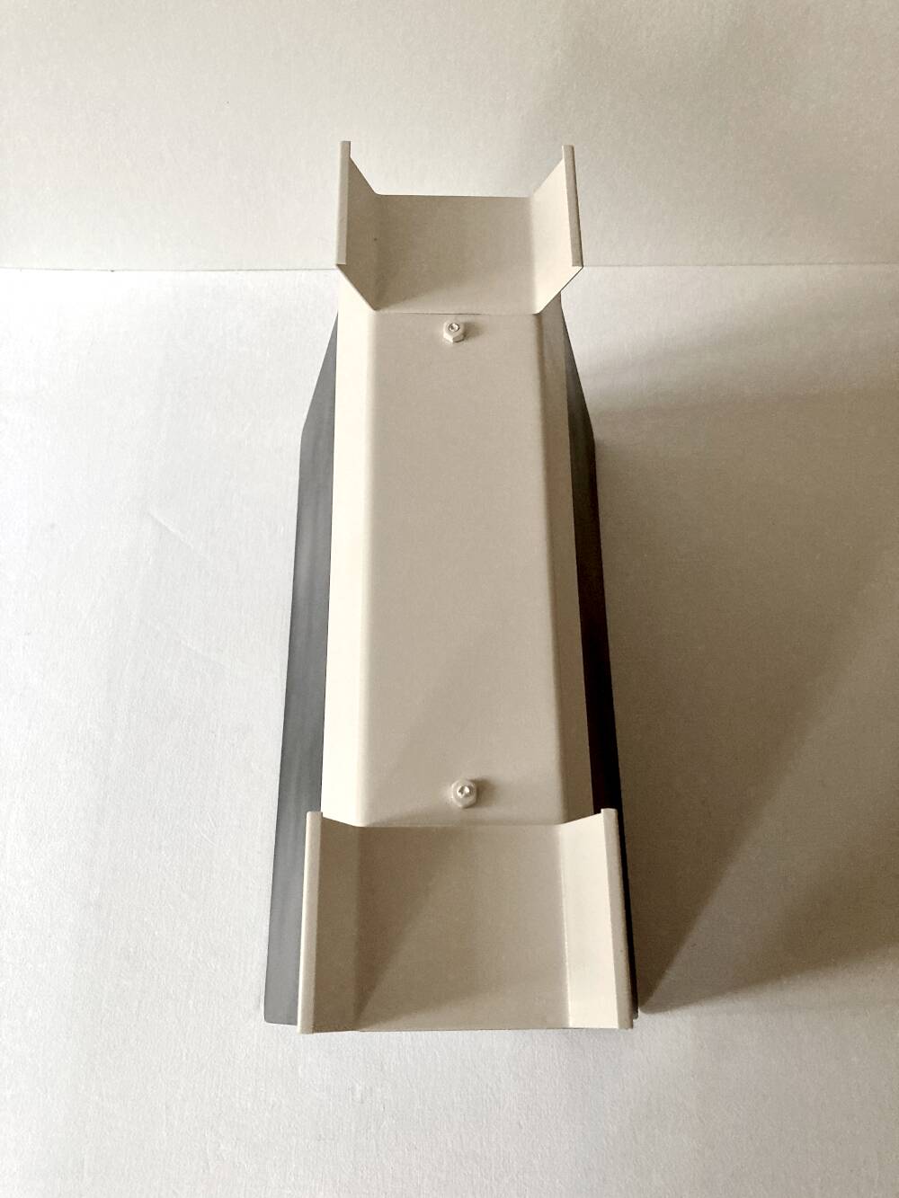 Black and cream metal magazine rack, 1950s.