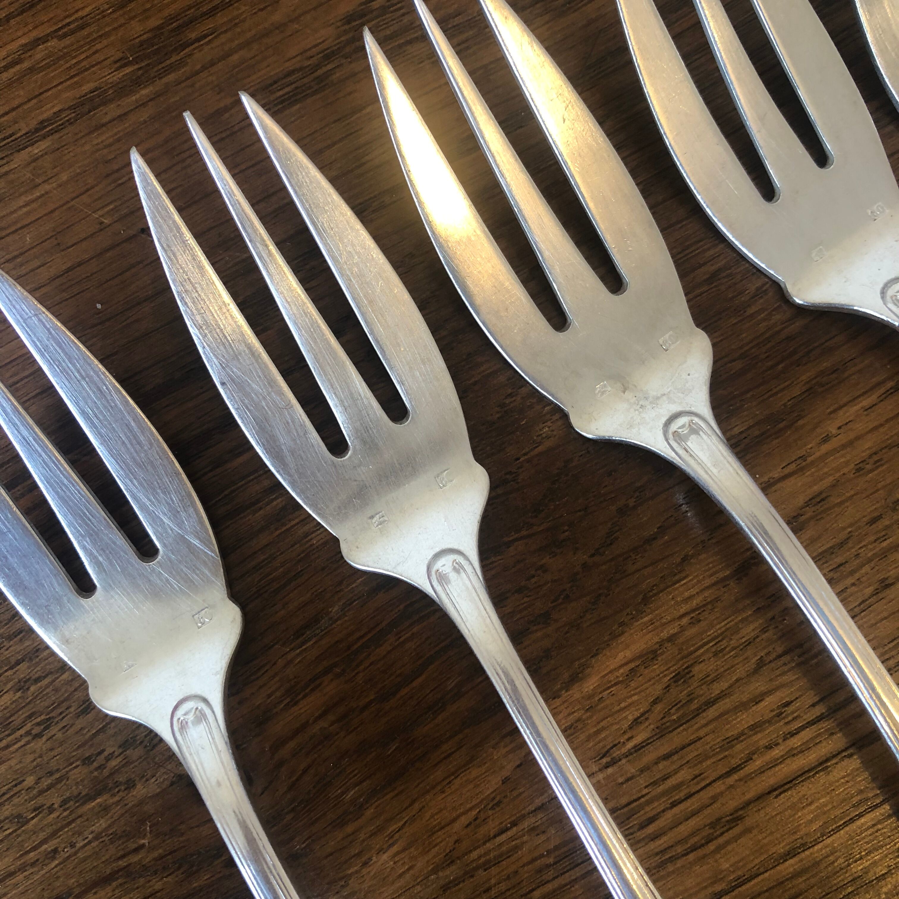 8 mismatched fish forks, silver metal