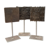 Set of three old ink pads on base