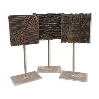 Set of three old ink pads on base