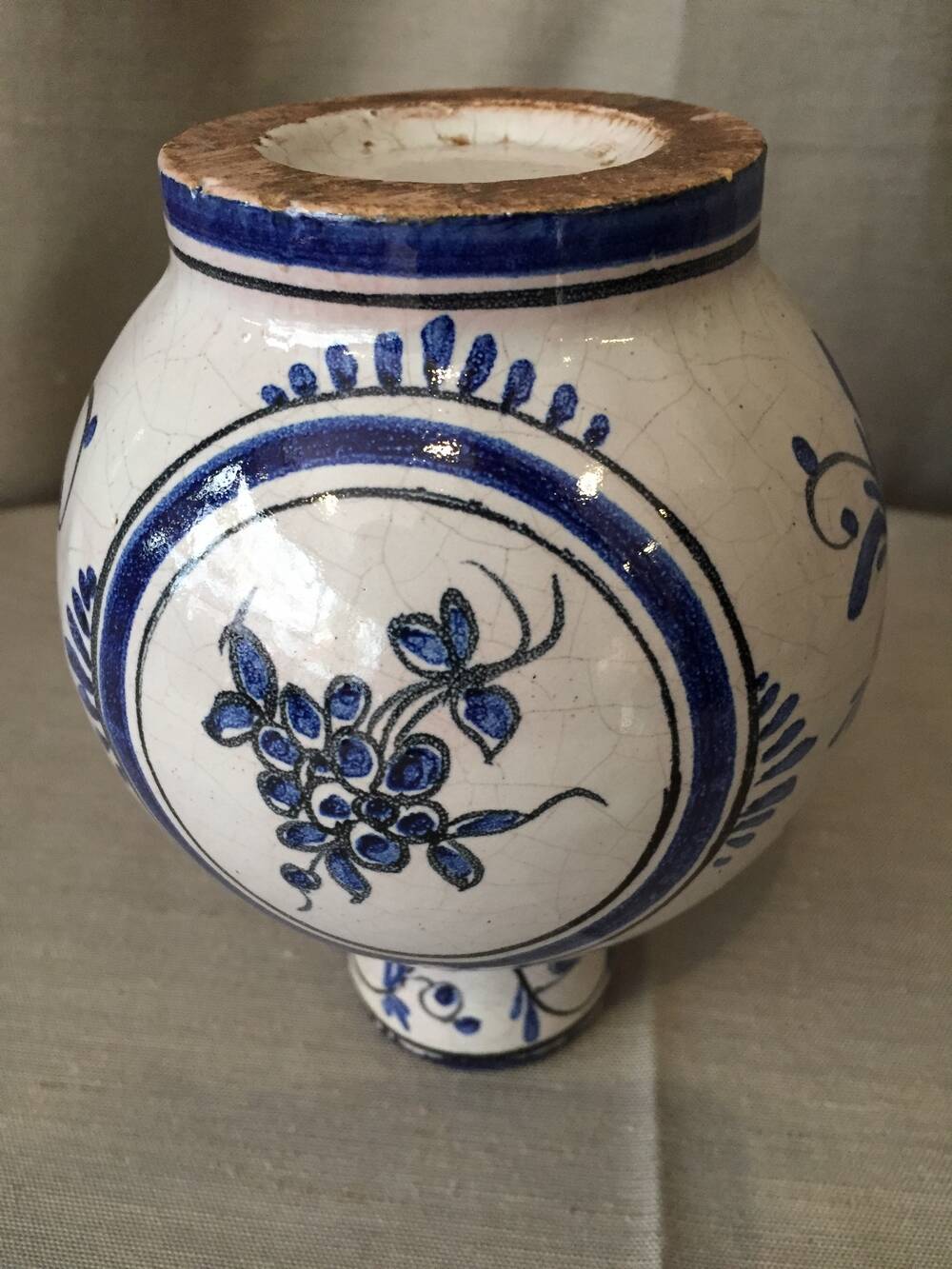 Small white decorative vase with blue floral decoration