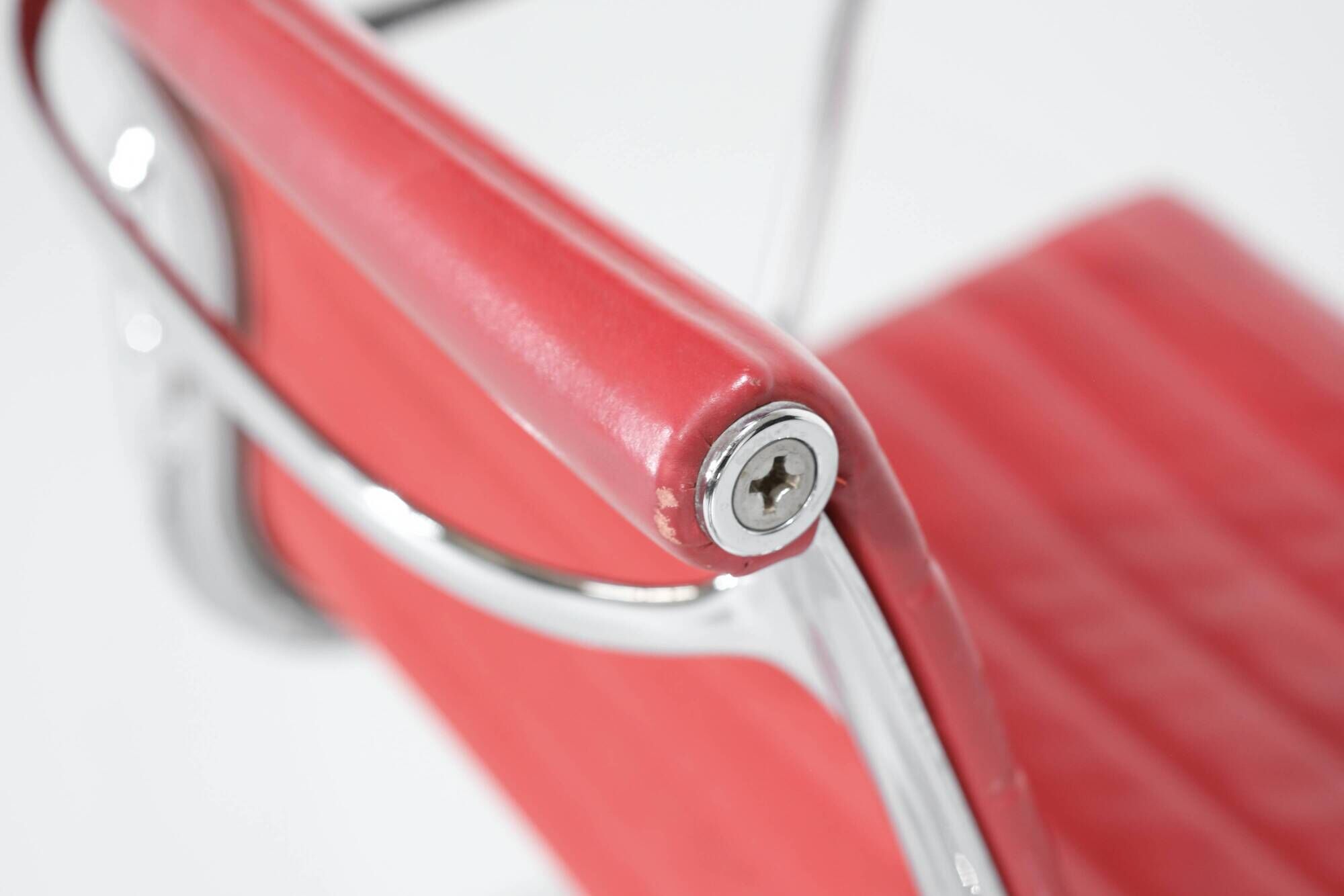 "EA 108" armchair in red leather, designed by Charles and Ray Eames for Vitra,