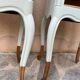 Renovated bedside tables in laurel green and light wood.