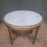 Oval coffee table in gilded wood in the Louis XVI style.