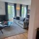 3-seater PMP Classy sofa in grey fabric and its 4 PMP cushions.