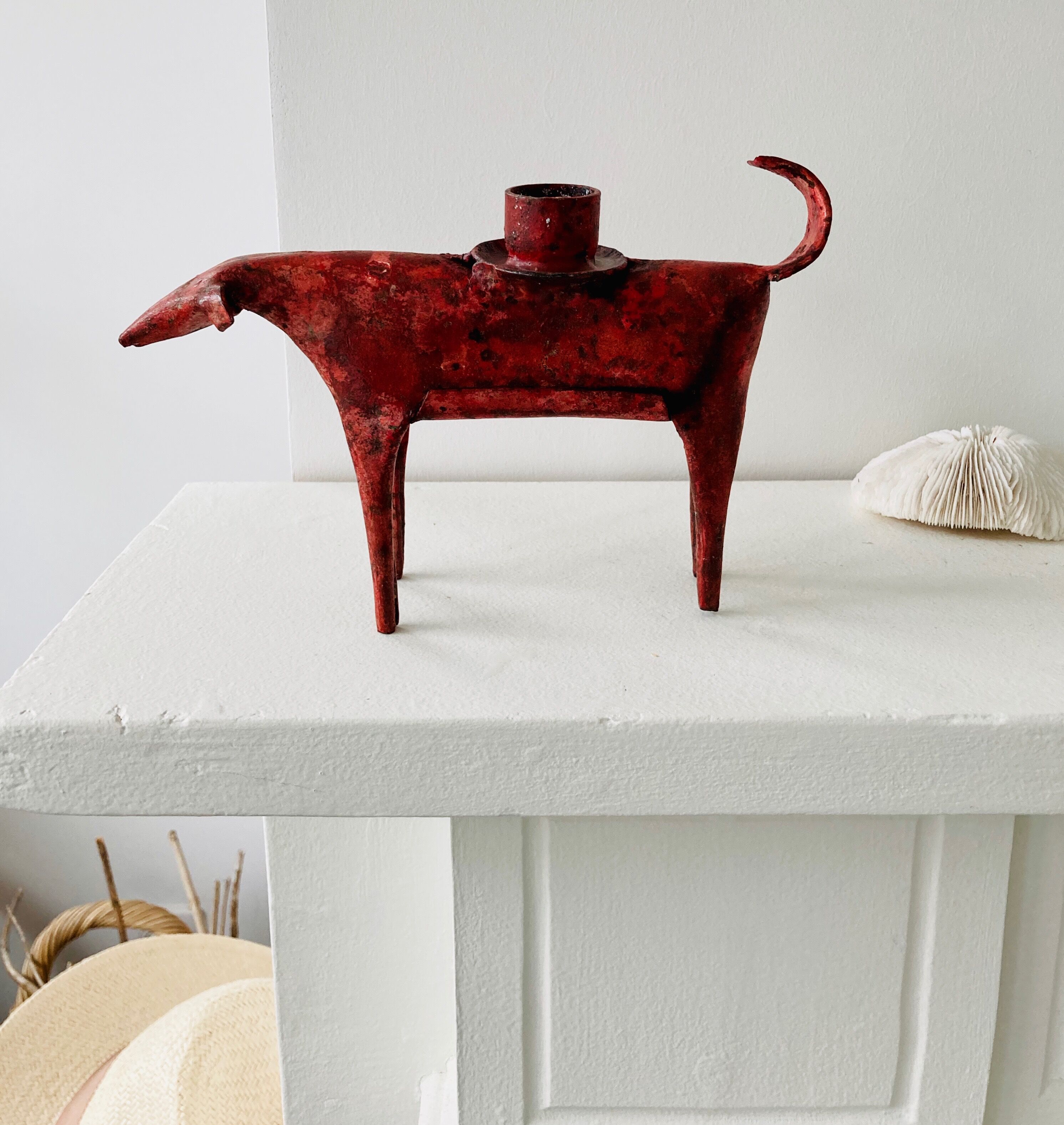 Zoomorphic candlestick made of red metal