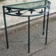 Grey-green wrought iron half-moon console with glass, 85cm.