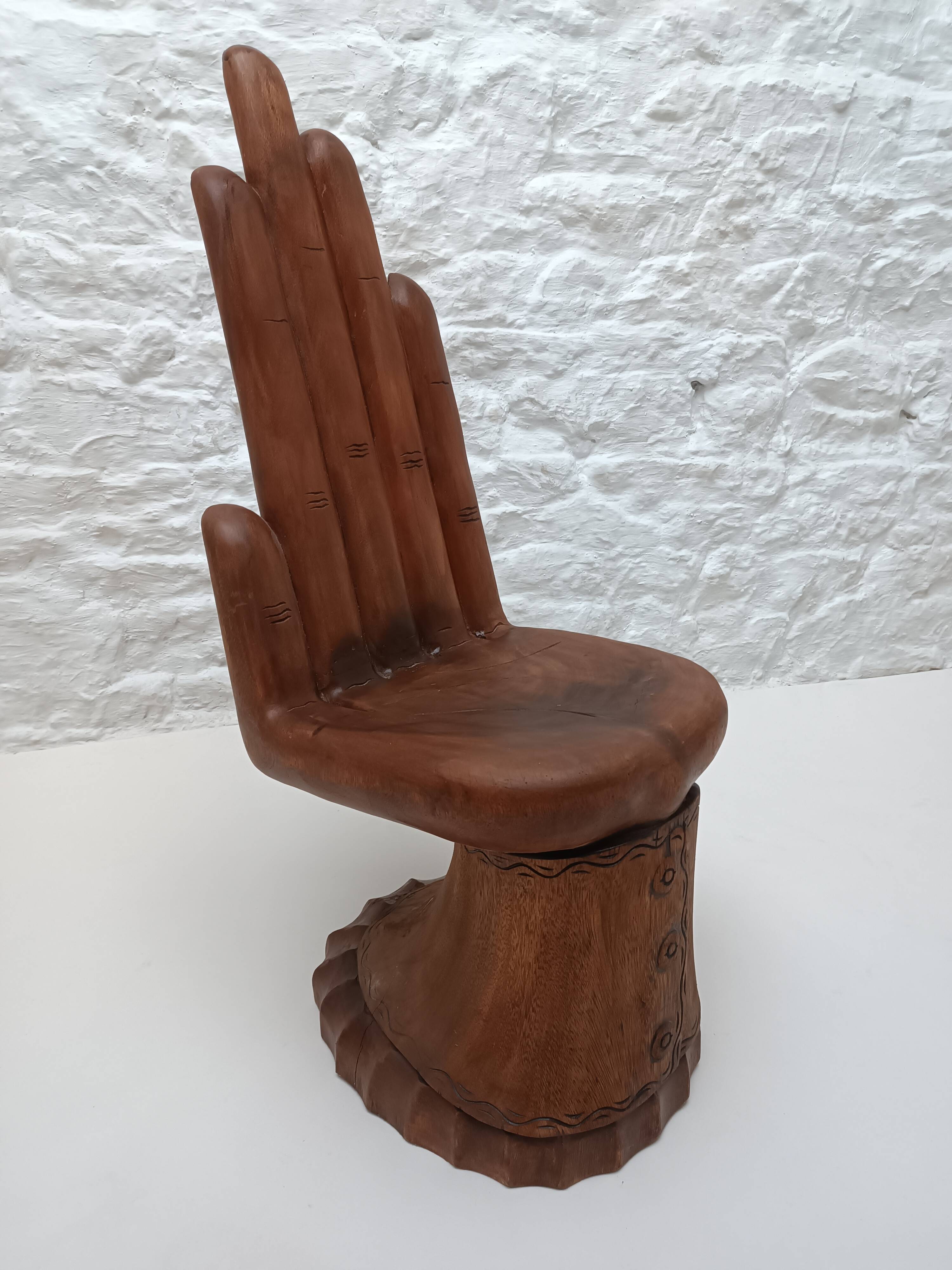 Sculpted wooden chair in the shape of a hand, 1960.