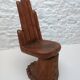 Sculpted wooden chair in the shape of a hand, 1960.