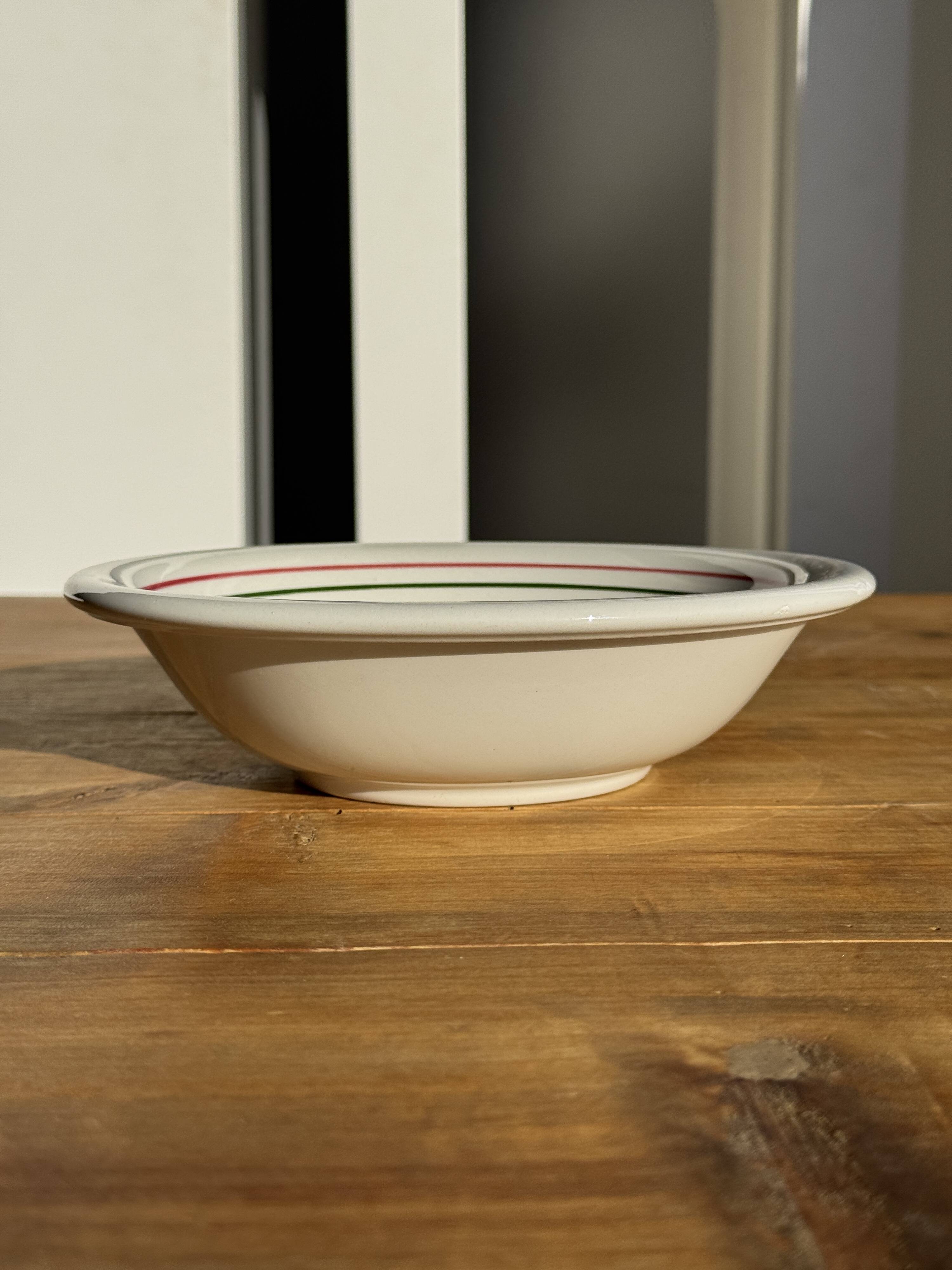 Small earthenware bowl from Italy, white with brown, green, and orange trim, D24.5.