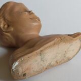 Bust of a small child in ancient plaster
