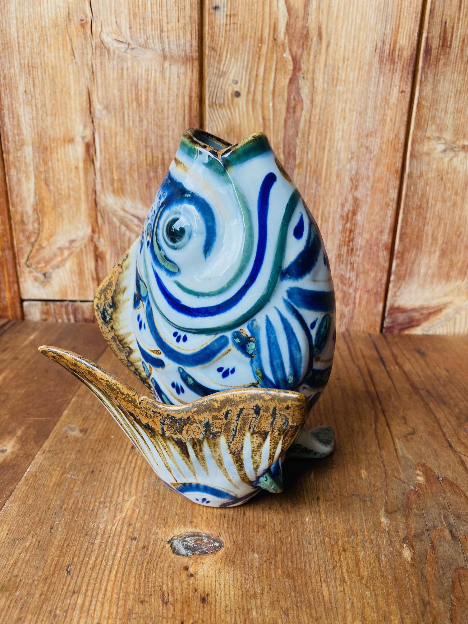 Blue ceramic zoomorphic vase in the shape of a poison.