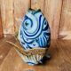 Blue ceramic zoomorphic vase in the shape of a poison.