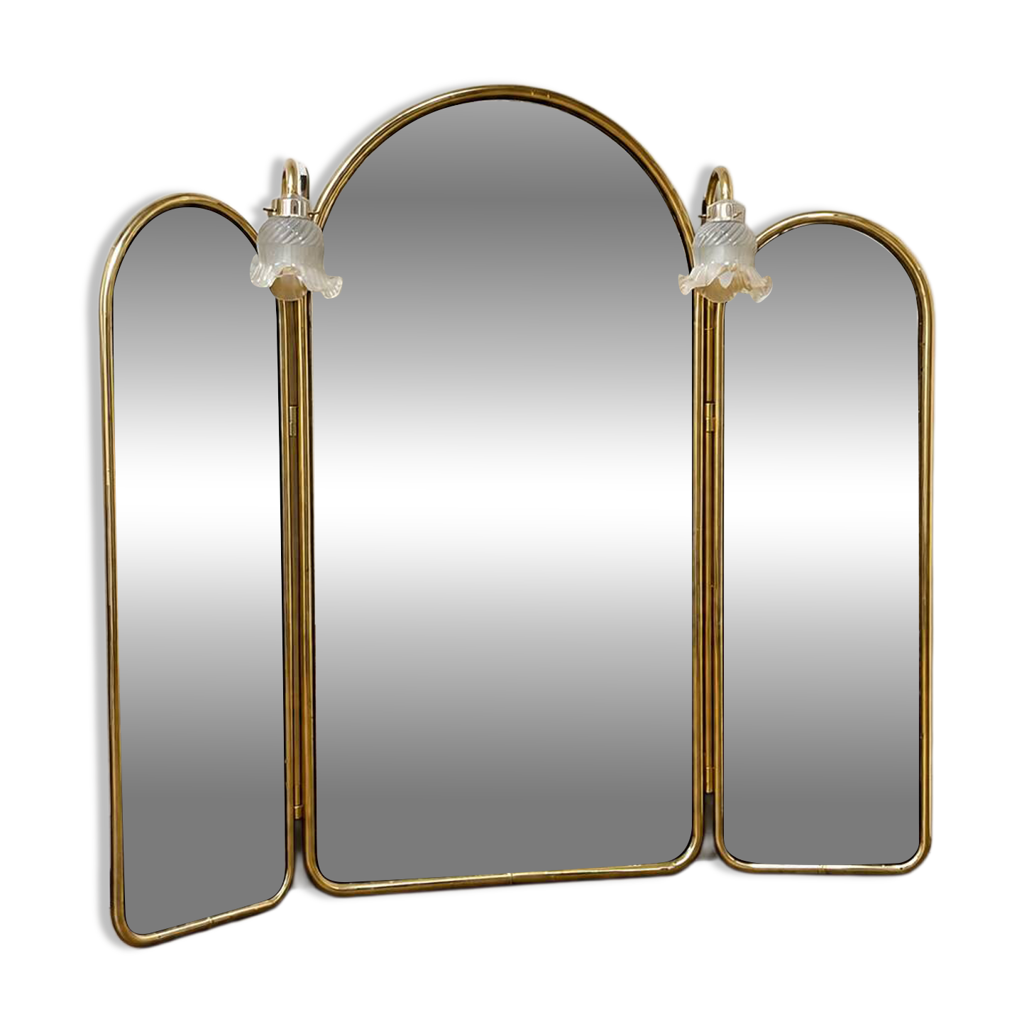 Vintage triptych mirror in brass with wall lights.