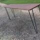 Console wood and metal with tapered legs.