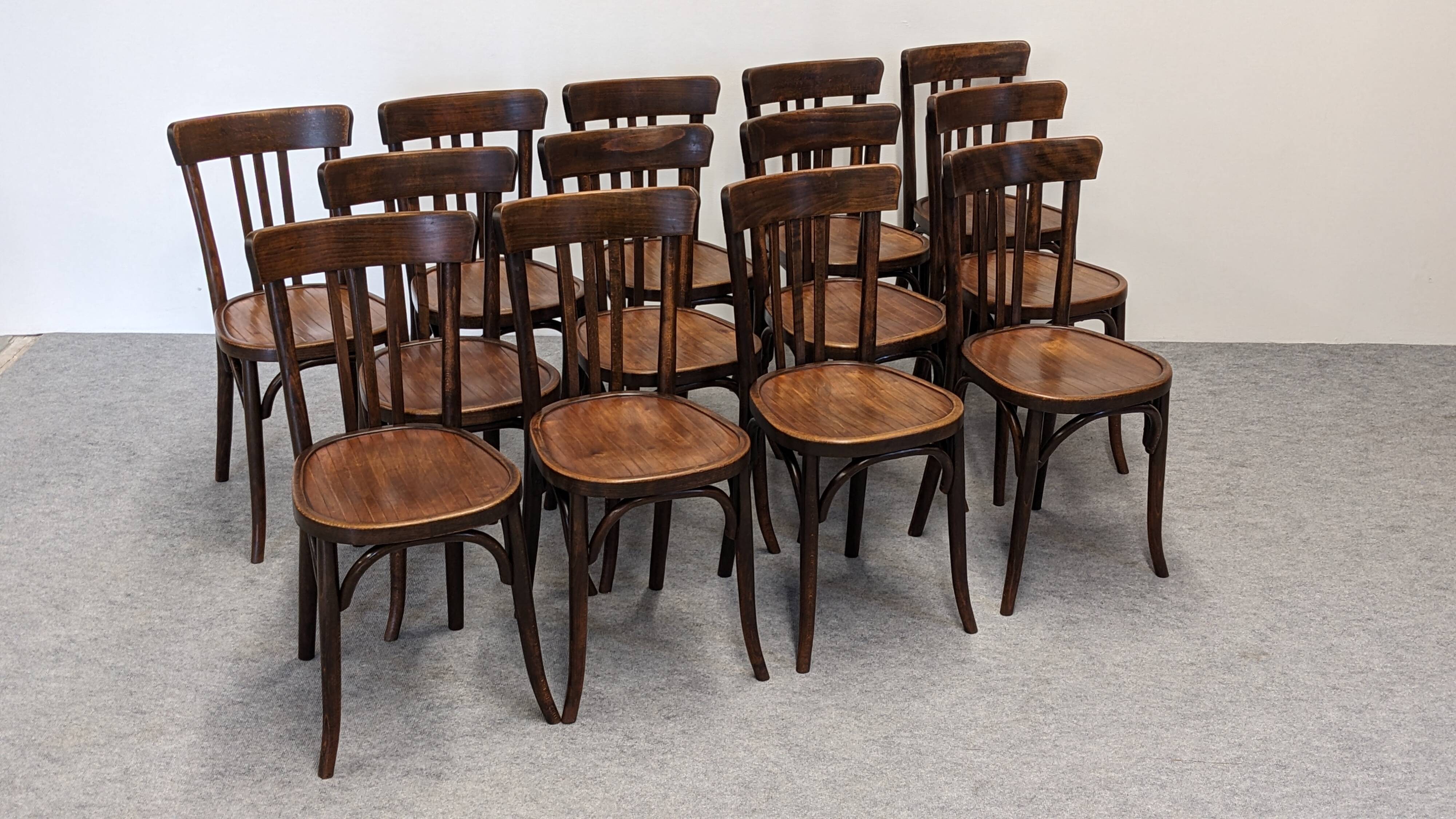 Set of 13 Baumann bistro chairs in bent beech, France circa 1930.
