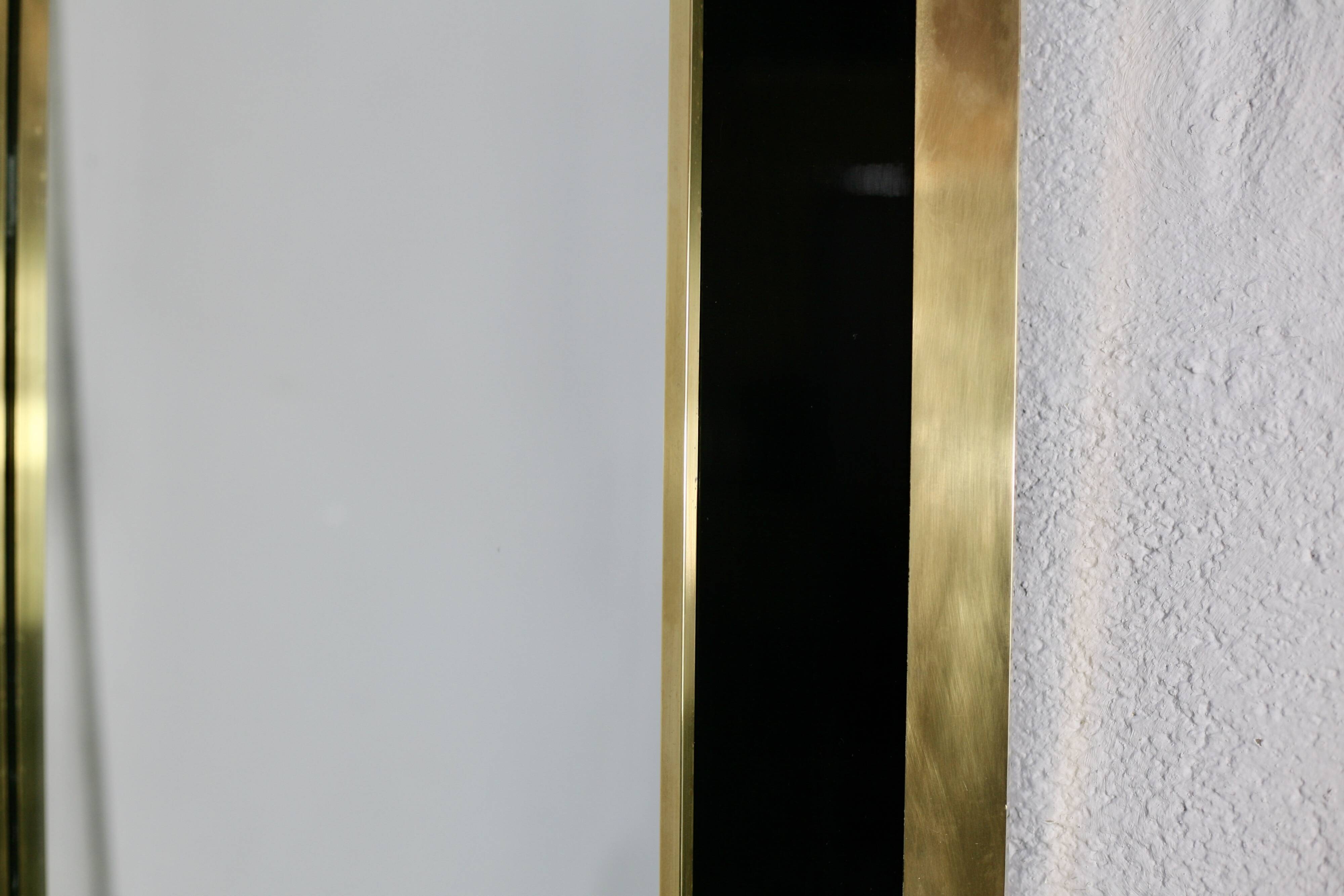 Jean-Claude Mahey mirror. Black lacquered wood and gold metal. 1970