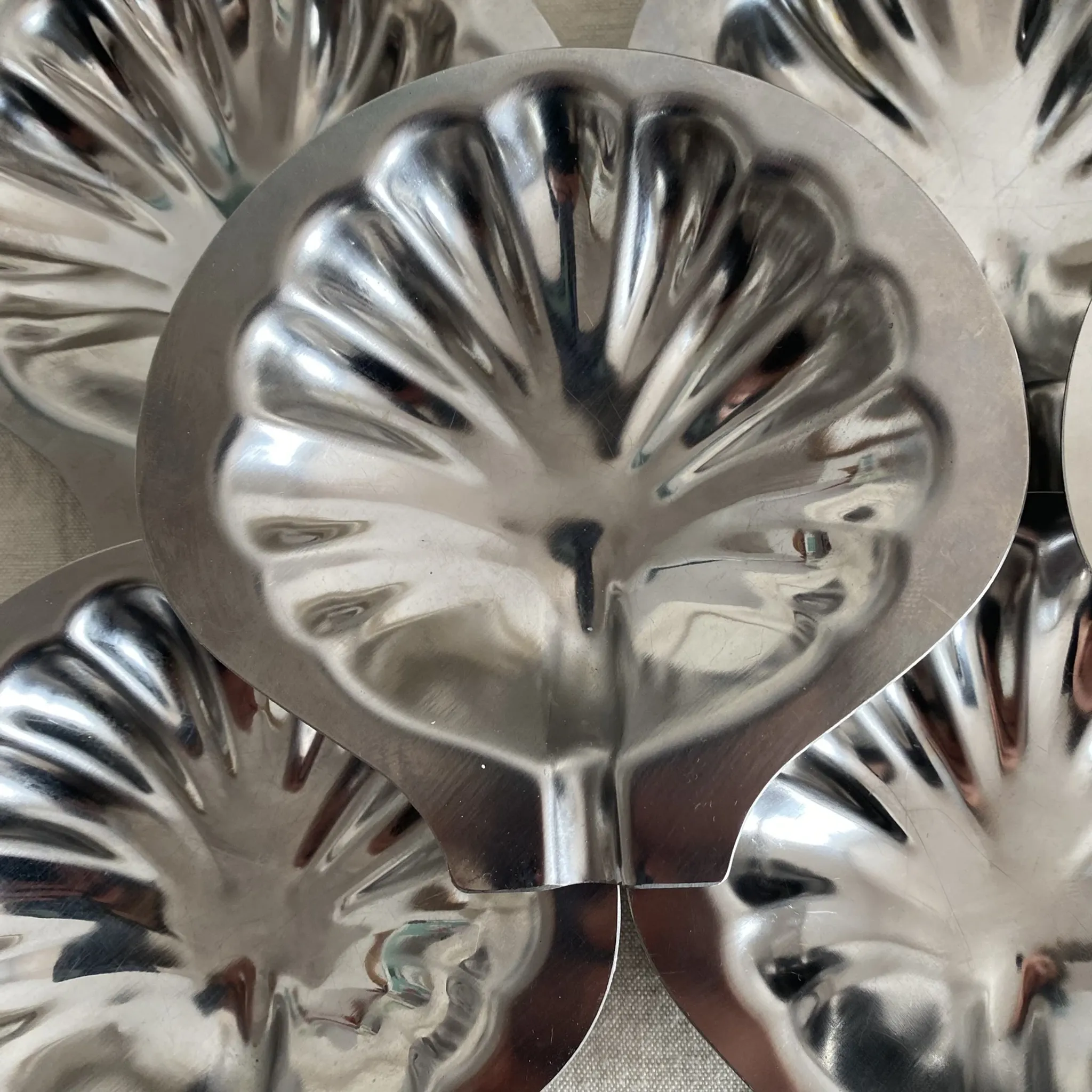 Set of 12 stainless steel scallop shells, 1970s-80s.