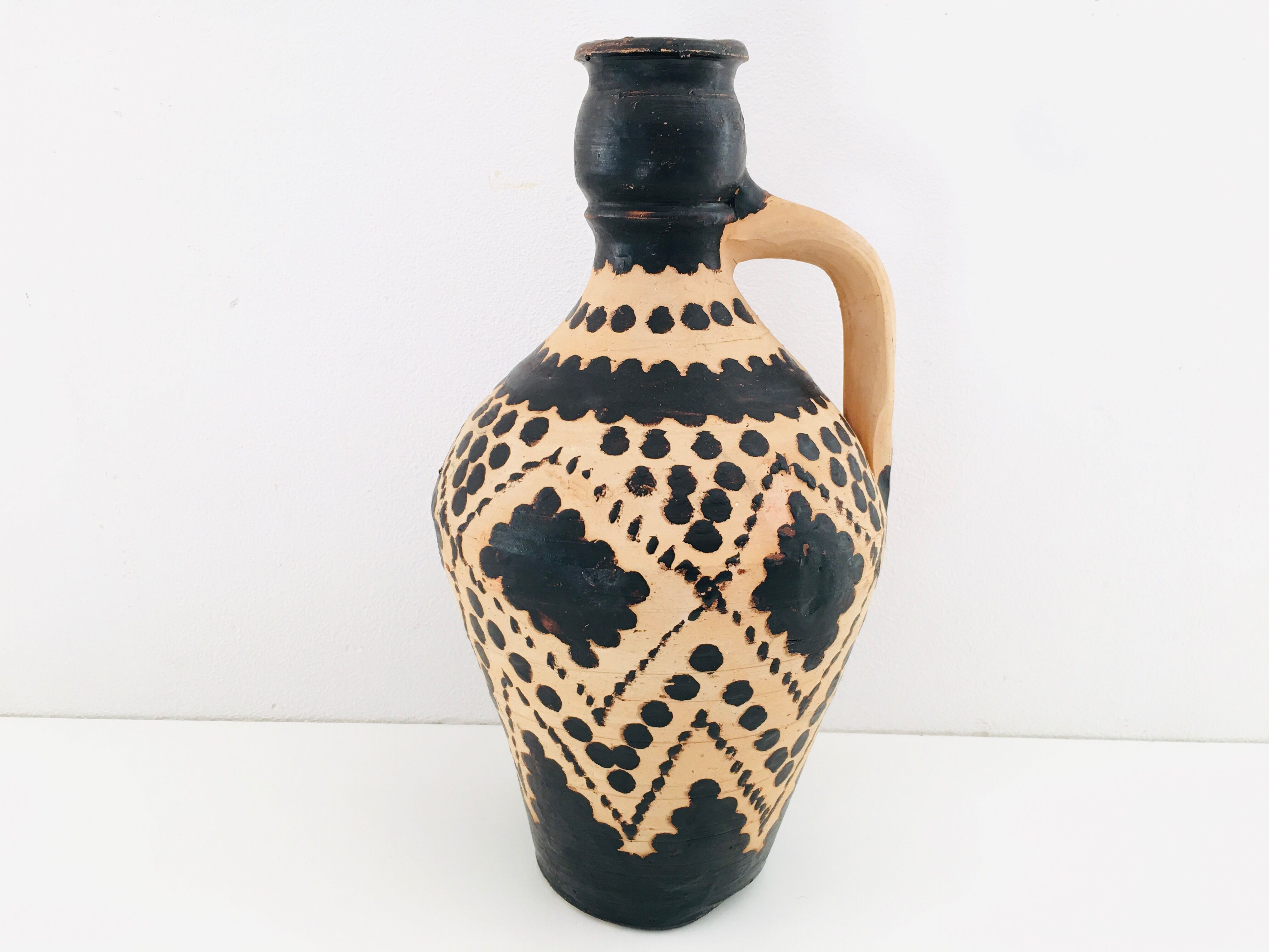 Raw and black terracotta jug